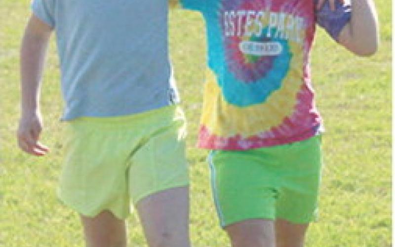Paislee Hodgson and Sophia Kitch took first place in their heat of the kindergarten three-legged race at the all school track meet, Friday.
