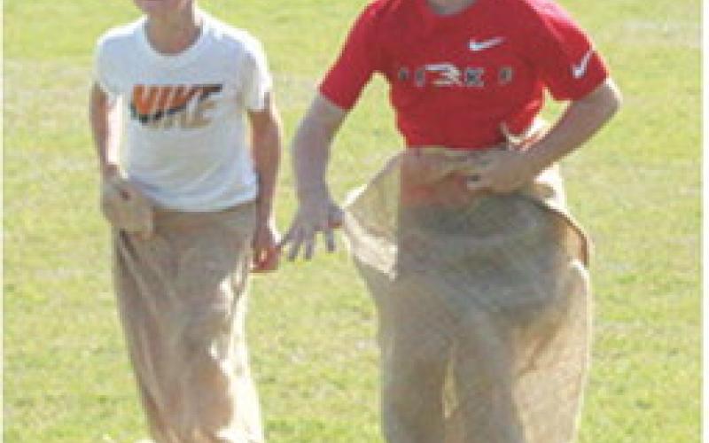 Kolson Kirk and Brooks Crain competed in the first grade boys sack race during the K-6 Elementary School Track and Field Meet, Friday, at Central School.