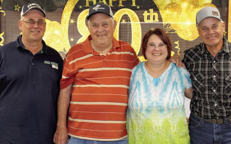 Lyman Crain (second from left) recently celebrated his 80th birthday. His children John Crain, Julie Thomas and Tim Crain hosted the party at the 4-H Building. Family and friends joined in the celebration.