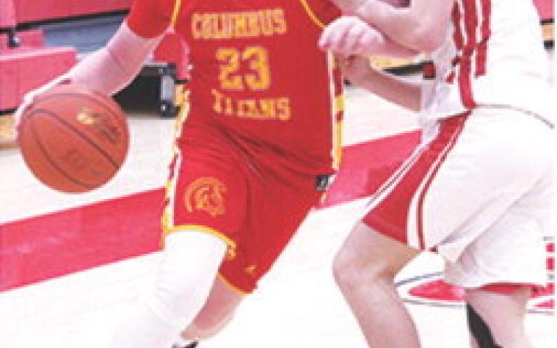 Jex Cheney drives to the basket past Baxter Springs defender, Caster Herrera, in the Monday loss on the road, 20-28. Cheney led the Titan Eighth Grade Team with eight points.