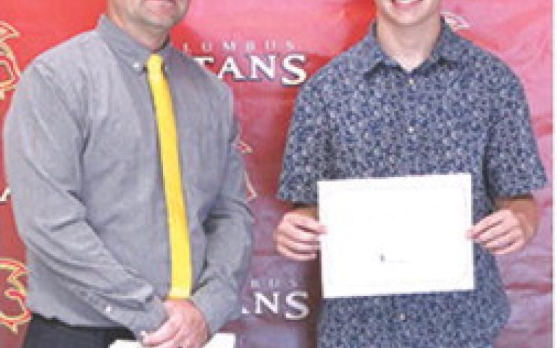 Jensen Hale, CUHS Senior, received a scholarship from Northeastern Oklahoma A&amp;amp;M College during the 2026 Senior Assembly at the Columbus High School Gymnasium. Presenting the scholarship was Jerry Smiley, USD 493 instructor.