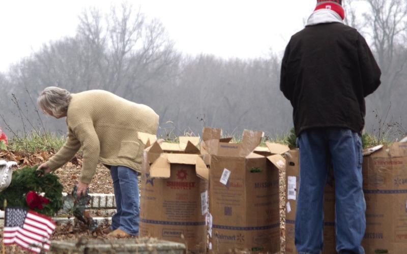The fresh live wreaths arrived in several large cardboard boxes which were unpacked and taken to the individual grave sites.
