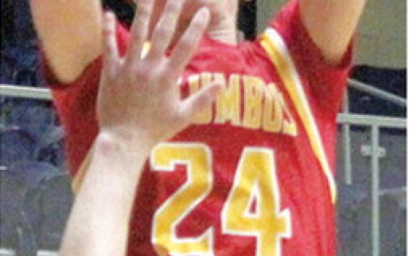 Columbus Titan Sophomore, Kooper Saiz, shoots for two points over Galena Senior, Jack Perry, in the Class 3A Quarterfinal loss in Galena, Friday, 42-75.