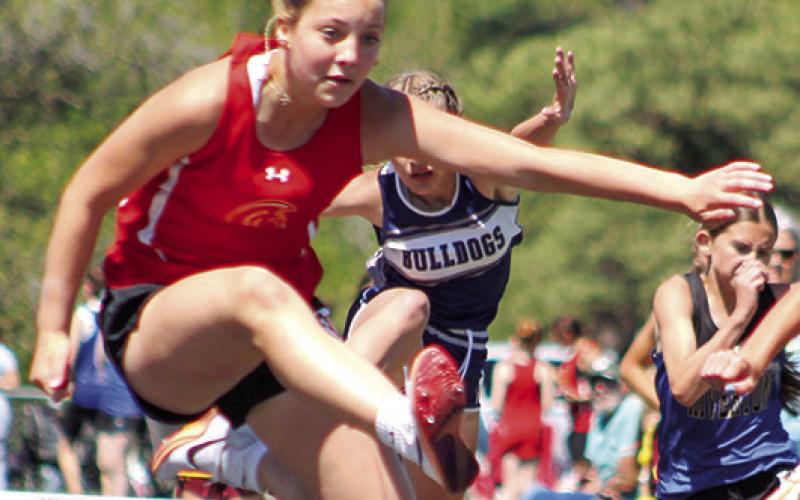 Lady Titan Brinleigh Meyer clears the hurdle during the Columbus Invitational, April 20, at the Central School Track. Thursday, she won the 100 Meter Hurdle event at the Frontenac Invitational with a time of 18.41 seconds and was a member of the 4x200 Meter Relay Team that also placed first at Frontenac. The Columbus seventh grader placed fifth in the 400M Dash and sixth in the 100M Dash.