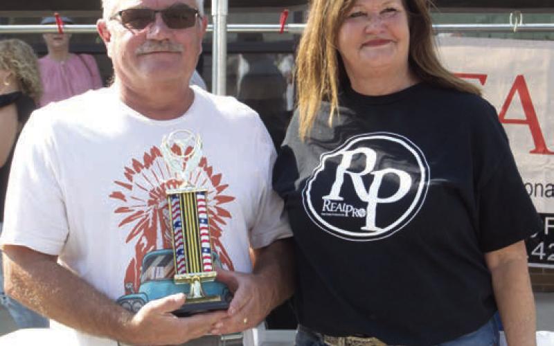 Rod Long showing a 1958 Chevrolet Apache took first place in the 1940 -1950 division of the Columbus Day Car Show. Becky McDaniel owner of Real Pro Real Estate presented the trophies.