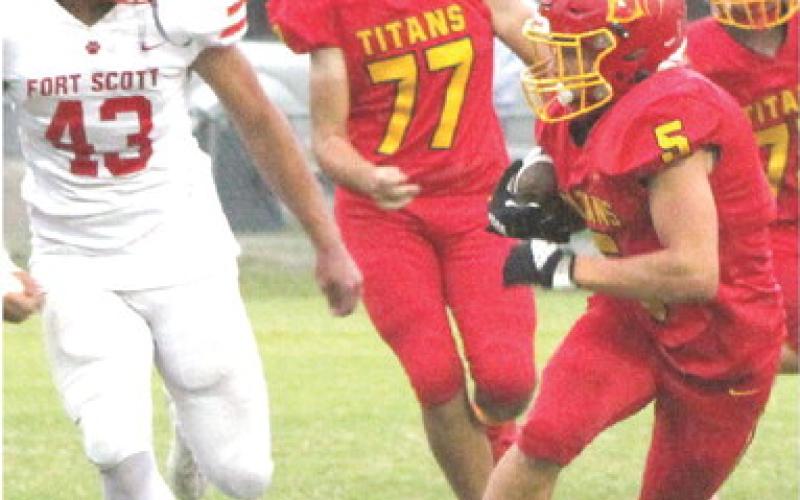 Titan Freshman, Braun Stone, gains yardage in the junior varsity loss to Fort Scott, 0-28, Monday, at Titan Stadium. Stone also highlighted the night for the Titan Defense with a fumble recovery. Junior, Jonah Smith, trails the play with Fort Scott Sophomore, Aiden Ogran.