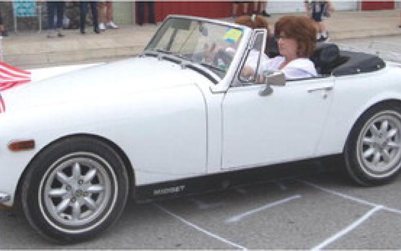 Stephanie and Courtney Ross went up the Weir Homecoming parade route in this classic MG Midget.