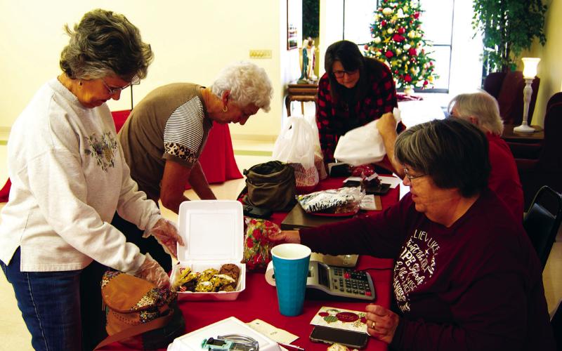 When the St. Bridgett’s Cookie Walk opened in Scammon Saturday morning the lines had formed outside the Parish Hall and it never slowed down until the cookies were exhausted. Making a purchase were Joyce Forrest and JoAn Sullivan.