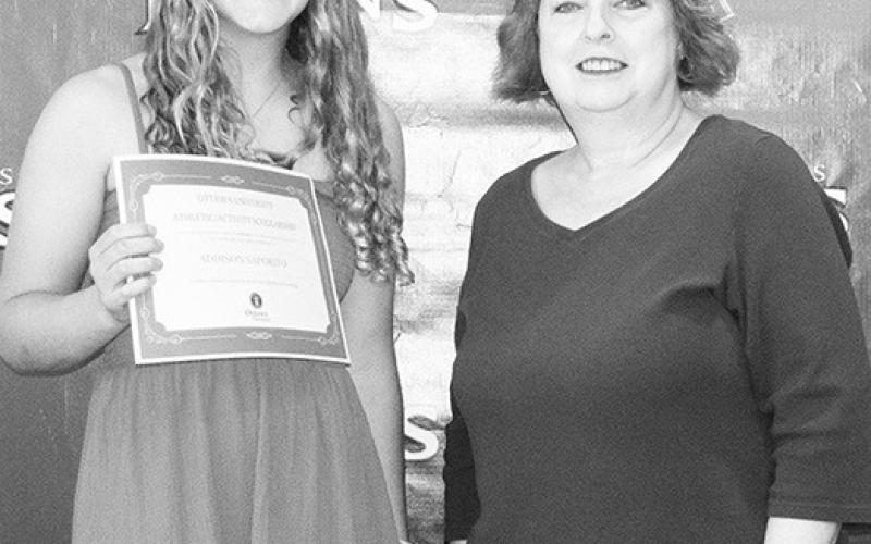 Addison Saporito received an Athletic/Activity Scholarship for $84,000 to wrestle at Ottawa University from Karen Langerot, CUHS English Instructor, during the May 19 Senior Assembly at the high school gymnasium.