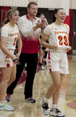 Lady Titan Seniors, Graci Major and Katie Simpson, and Lady Titan Head Coach, Matt Leet, celebrate a win at home during the MOKAN Classic Tournament early in the 2023-24 season. Columbus will be back on the court January 5 at Girard for boys and girls games beginning at 4:30 p.m. with junior varsity action.
