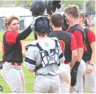 Kash Smith, Titan Freshman, is congratulated at home plate by his teammates following his third inning, base clearing, home run in his first varsity start for the Titans. The hit was Kash’s second grand slam of the game, tying a state record for most grand slams in one game. A single in the fourth inning gave Smith a total of nine Runs-Batted-In in the 14-1 win over the Bulldogs in Galena, Monday. Columbus completed the sweep with a 10-0 win in game two.