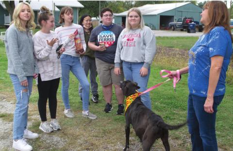 Riverton High School Teacher Margaret Radlund holds a dog by the leash before her FCCLA students, Katie Burge, Karli King, Joanna Lewis, Elizabeth Feldcant, Andy Jones, and Bailee Riggs. The dog is seen wearing a bandana that one of Radlund’s other classes had made for the animals beforehand. Photo by Jacob Spencer.