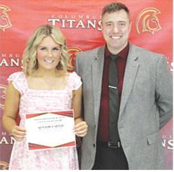 Kenadie Carter received a $250 Harold Brandenburg Math and Science Scholarship from USD 493 Math Instructor, Luke Henke, during the 2025 Senior Assembly at the CUHS Gymnasium, May 16.