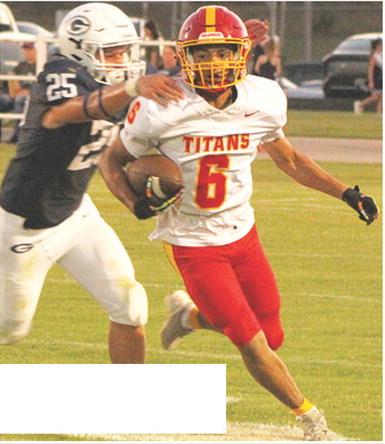 Titan Freshman, Jaydan Dohle, breaks away from Senior, Evan Wittenmyer as he takes off on his 80-yard catch and run touchdown from sophomore, Cole Howard in Friday’s 13-20 loss in Galena.