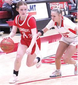 Lady Titan Junior, Bentley Townsend, drives past junior, Layla Weaver, on her way to the basket in Friday’s homecoming win over Baxter Springs, 4126. Bentley led the Columbus with 11 points.