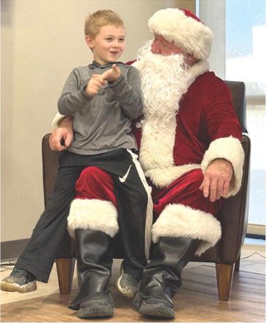 An early visit to Cherokee County by Santa Claus was an opportunity for Jacob Schreiner to share his Christmas wish list. Schreiner and the rest of Suzette Henderson’s Kindergarten class at Park traveled to American Bank Wednesday to meet Jolly St. Nick. Courtesy photo.