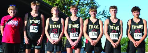 The Columbus Unified High School Boys Cross Country Team took third place in the Columbus Invitational Meet, Tuesday at the Brush Creek Golf Course. Columbus Head Coach Amanda Strickland is shown with her team as they are introduced for the medal stand. Dane Merrick, Kolton Delmont, Carter Woodcock, Easton Long, Levi Simpson, and Drake Laurance. Courtesy photo.