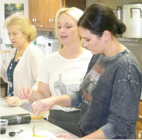 Large crowd learns homemade pasta making techniques