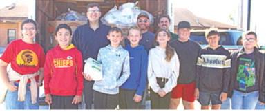 Jake LaTurner, Jake Conard and Daniel Koucky were joined by Columbus sixth graders to unload turkeys to be used in the Thanksgiving baskets.