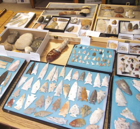 Finding traces of human history is always an exciting experience. There’s something extra special, about discovering a site or artifact. Janet Hand has spent hours in the fields and along creek beds looking at the ground for prehistoric tools or Native American arrowheads. (Above) is a portion of her collection including both tools and hunting items. (At right) Janet holds the head of a tomahawk which was found on the farm of Floyd Lyerla near Crestline in Cherokee County.