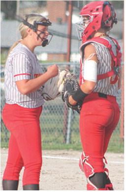 Lady Titan Seniors, Morgan Richards, pitcher, and Adalie Grafel, catcher, meet for a conference during home games against Galena, Monday, at Rockette Field in the Columbus Community Ball Park. Galena swept their hosts 15-3 and 11-9 in a CNC League double header.