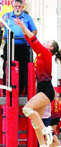Lady Titan Junior, Ruby Stover, returns the ball over the outstretched hands of the Humboldt player at the opposite side of the net for a point during the Lady Titan Jamboree, Thursday, at the Columbus Unified High School Gymnasium. The Lady Titans return to their home court for a home triangular with Cherryvale and Neodesha, Thursday. The C Team will take the court at 4 p.m. followed by the Columbus and Neodesha varsity and junior varsity squad at 5 p.m.