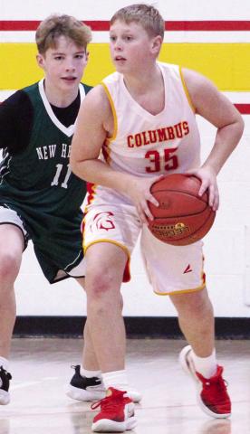 Jax Sharp, Columbus Junior High Seventh Grader, looks to pass up court against his New Heights Christian Academy opponent, Jay, during the 32-14 Titan win at the Columbus Jamboree, Saturday.