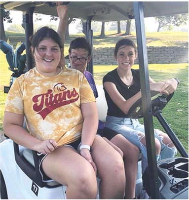 Lady Titan Freshman Golfers Jaiden Campbell and Natalie Wary with their golfing buddy head out to their tee off hole during the Special Olympics Golf Tournament held at the Pittsburg Golf Course last week. Courtesy Photo.
