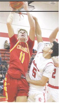 Titan Sophomore, Jonas Stover, scored 27 points in the Columbus season opener at Oswego. Demitri Wiliamson, Indian Sophomore, defends. Williamson led Oswego with 16 points.