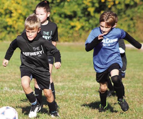 Roman Atkinson, Ruby Ellis and Phoenix Rider battle down the field during the Columbus Area Youth Soccer season in September and October at Eddington Park. The season wrapped with team parties at the pumpkin patch.