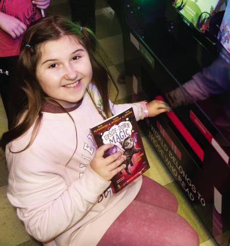 A ribbon cutting ceremony was held Wednesday for the new book vending machine installed at Central Elementary in Columbus. Addlyn VanGilder showed off her newly chosen book.