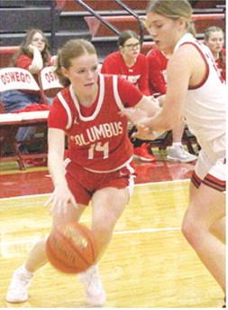 Lady Titan Junior, Bentley Townsend, drives to the basket past Oswego Freshman, Colby Pease in the, 31-28, Columbus season opening win at Oswego. Bentley scored eight points in the win.