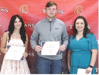 Allison Burns and Brandon Stice received the Columbus Junior, Senior High School Business Scholarship in the amount of $350 each from USD 493 Business Instructor, Laura Boeckman during the 2025 Senior Assembly, May 16, at the Columbus Unified High School Gymnasium.