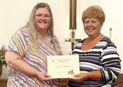 The Starr and Eugenia Smith Scholarship was presented to Pastor Dorcia Johnson by Athena Mc-Colm. Courtesy photo.
