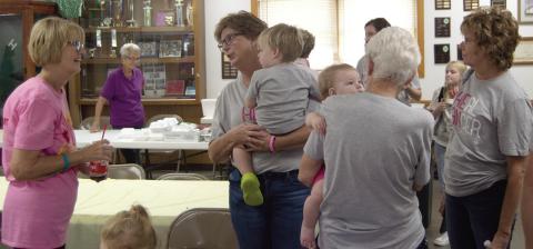 Friends and family of Traci Spear (holding grandson James Hodgson) attended the pulled pork fundraiser held at the 4-H Building September 28. Proceeds will go for treatment and travel expenses.