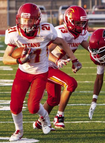 Elijah Shoemaker, Titan Seventh Grader, races toward the goal line with blocker, Hayden Kellogg on his heels. Elijah was just short of the goal line, in a 6-14 loss at Chanute, Thursday. Photo by Kristin Sharp.