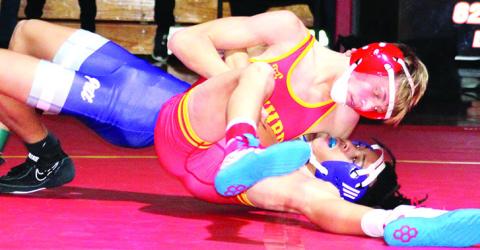 Cal Saporito, Titan Sophomore, pinned his Pittsburg opponent in a dual on his home mats, Thursday. Cal won then 113-pound weight class but Columbus lost the dual, 20-44, to the Purple Dragons at the CUHS Gymnasium.