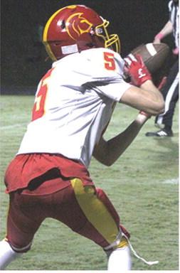 Titan Senior, Gavin DePratt, makes a catch in a wide open field from sophomore, Jonas Stover, and runs in for a 52-yard touchdown to put Columbus on top, 13-8, in their win over the Lions in Baxter Springs, Friday night. Junior, Braun Stone, ran in the two-point conversion to put the Titans back on top, 15-8, with seven minutes top play in the game.
