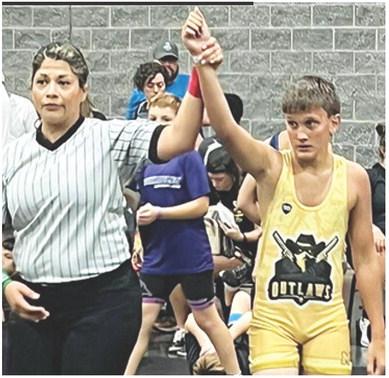Briggs Johnson has his arm raised in victory following a match in the Cowboy Rumble at Branson, Mo., August 2-3. Courtesy photo.