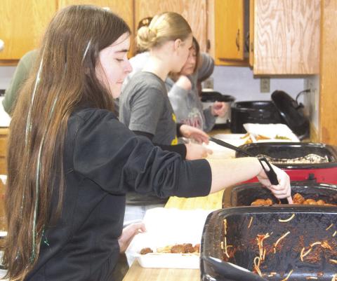 During the recent spaghetti dinner fundraiser for Eva Maxton, Kora Welch was helping out in the kitchen. She was boxing up spaghetti and meatballs for those attending. News Report photo by Shawn Churchill.