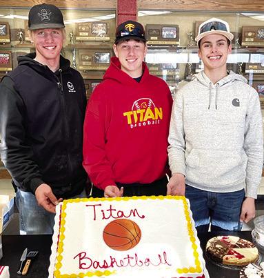 Titan Seniors, Cole Youngblood, Huck Hallam, and Derek Krause were celebrated with a special cake at the CUHS Boys Basketball Banquet, Monday, at the Columbus High School Gymnasium Lobby. (Courtesy Photo.)