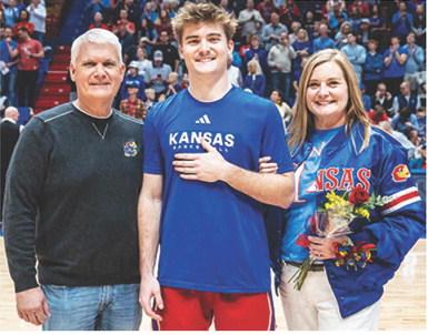 CUHS Graduate, Patrick Cassidy is joined by his parents, Jeff and Julie Cassidy during Senior Night at the Phog recognition at the final Kansas University Jayhawk home game. Patrick recently received 2025 Winter All-Academic Big 12 honors at KU. Courtesy photo.