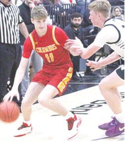 Titan Freshman, Jonas Stover, works toward the basket against Raider Junior, Jake Wegner, in the CNC loss at Frontenac, Monday. Stover led the Titans with eight points.