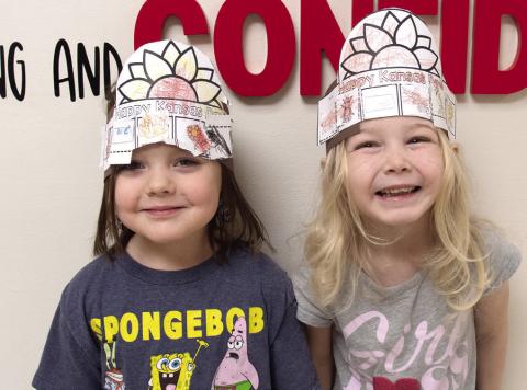 Youngsters at Columbus schools recently celebrated Kansas Day. Olivia Meredith and Hattie Napier created sunflower hats to recognize the state flower.