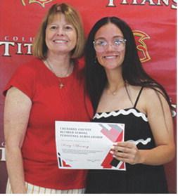 Katy Mooney received a $400 scholarship from the Cherokee County Retired School Personnel from Regina Jameson during the 2025 Senior Assembly, May 16, at the CUHS Gymnasium.