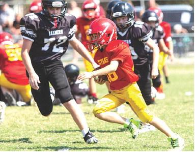 The Columbus Fifth and Sixth Grade Titan Team hosted Frontenac, September 16, at Titan Stadium. Tanner Scott ran up against some big guys on defense during a good run. The visitors clipped the locals, 26-20 in double overtime, handing Columbus their first loss of the season. Photo courtesy Kristin Sharp.