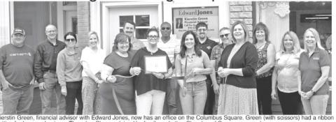 K cutting for her new business Thursday. She was joined by family and other Chamber of Commerce members as she was welcomed to the communi Green, financial advisor with Edward Jones, now has an office on the Columbus Green (with scissors) had a ribbon