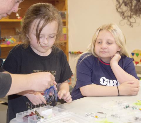 Columbus Public Library recently held a tackle box workshop for kids. Chiildren were able to build their own tackle boxes. Adaline Jameson and Layla Stewart enjoyed adding lures to their boxes during the event. News Report photo by Tanya Woolsey.