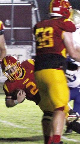 Jett Tanner, Titan Senior, dives across the goal line for the Titans first touchdown of the game from six yards out to cut Riverton’s lead, 6-7, in the first quarter of the Ram win, 21-12, Friday in Columbus.