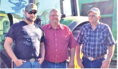 Charles Atkinson and his brothers on their Columbus farm. Rick, Charles and Keith were part of the local farming operation. Courtesy photo.